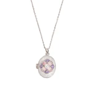 Detail of oval locket necklace featuring enamel flowers and white pearl on silver chain