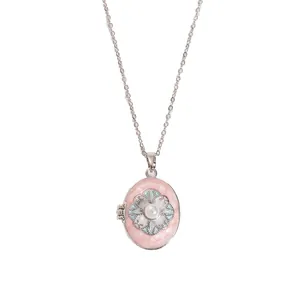 Detail of vintage oval locket necklace with pink enamel and pearl flower inlay