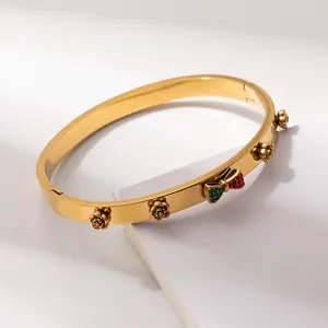 Elegant gold bangle with 3D metal roses and crystal bowknot on white steps background