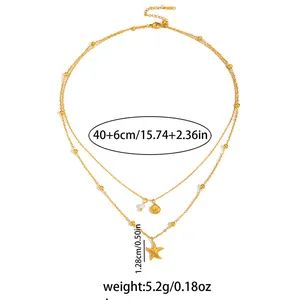 Collana dorata a due strati con ciondoli a stella marina e conchiglia marina