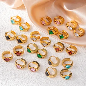 Chic gold-plated huggie earrings with multi-color zircon stones on white marble and silk