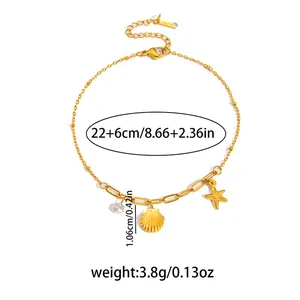 Bracciale dorato con ciondoli a stella marina, conchiglia e cristallo lucente