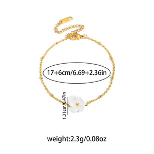Elegant gold titanium bracelet featuring white flower charm and adjustable chain link
