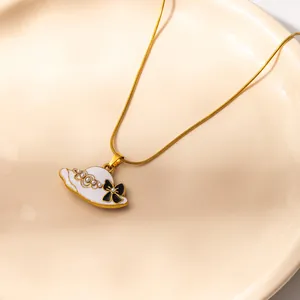 Golden snake chain necklace with white enamel sun hat pendant and tiny pearls