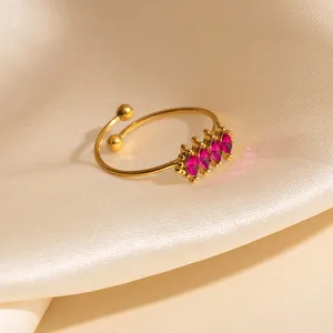 Adjustable gold open ring featuring four marquise-cut pink zircon stones on satin