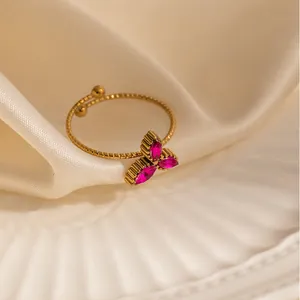 Adjustable gold ring with three marquise-cut pink zircon stones and beaded texture