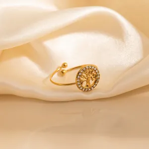 Golden Tree of Life open ring with sparkling cubic zirconia on cream silk background