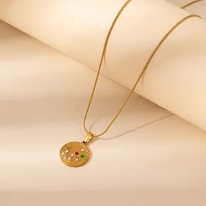 Golden 12 Zodiac necklace featuring red and green star details with white cubic zirconia