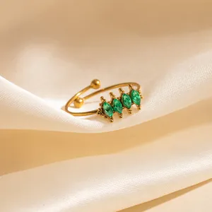 Adjustable gold butterfly ring featuring four marquise-cut green zircon stones