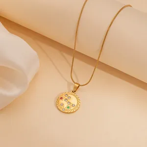 Golden zodiac necklace with circular pendant, snake chain and colorful enamel stars