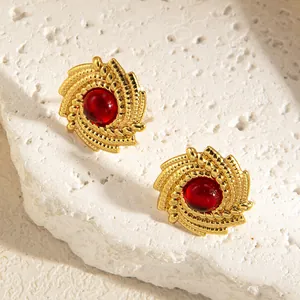Vintage gold spiral earrings featuring a large round red gemstone for women