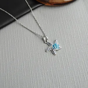 Starfish pendant necklace with deep blue crystals and sea-inspired enamel details
