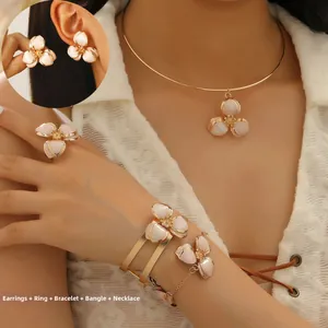 Dettaglio del set di gioielli floreali in cinque pezzi con petali bianchi su modella