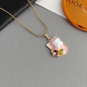Vintage gold chain necklace with pink enamel rectangle pendant and white rose detail