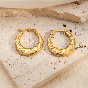 Elegantly twisted gold titanium steel hoop earrings with embossed texture for women