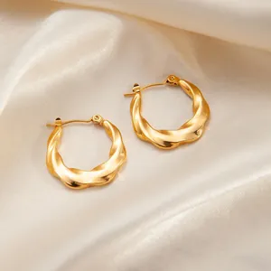 Chic twisted golden hoop earrings in high-shine titanium steel with a minimalist finish