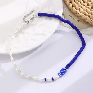 Detail of bohemian ocean necklace featuring blue fish bead and mixed ceramic pearls