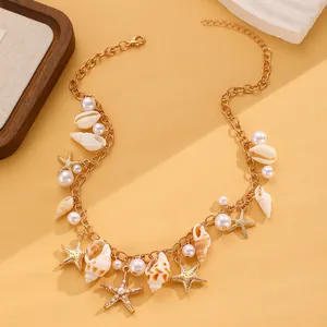Dettaglio della collana bohémien dorata con stelle marine, perle e conchiglie