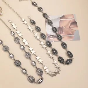 Detailed macro view of retro silver metal waist chains with star and oval embossed links