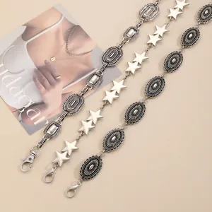 Detailed view of three vintage silver metal waist chains with star and oval embossed links