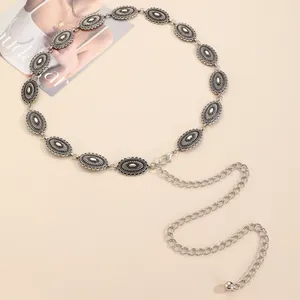Detailed macro of vintage silver metal chain belt with ornate sun flower engravings