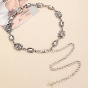 Detail of vintage silver metal waist chain with embossed geometric texture and clasp