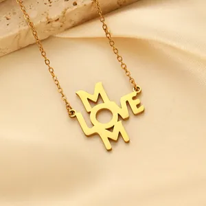 Detailed view of gold plated LOVE MOM pendant on a fine link chain with stone texture