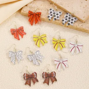 Bow-shaped acrylic earrings collection featuring basketball, soccer, and football patterns