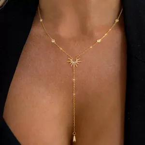 Elegant gold Y-shaped necklace featuring a sunburst pendant and drop pearl accents