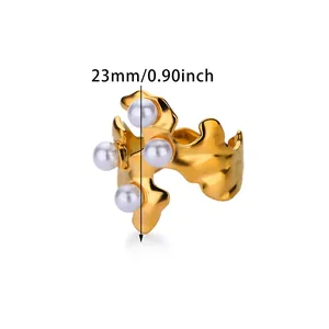 Close-up of pearl heart ring showing 23mm height with golden liquid metal texture