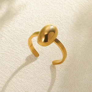 Close-up of golden vintage ring with oval metal dome design and flat band details