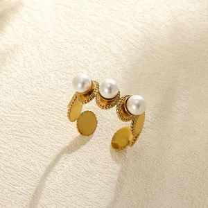 Detailed view of a gold vintage open ring with delicate beading and three white pearls