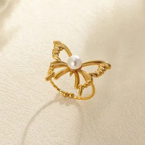 Detail of vintage gold butterfly ring with central pearl inlay and engraved wings