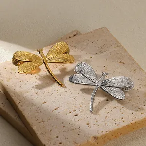 Retro titanium steel dragonfly brooches in gold and silver with hollowed wing textures