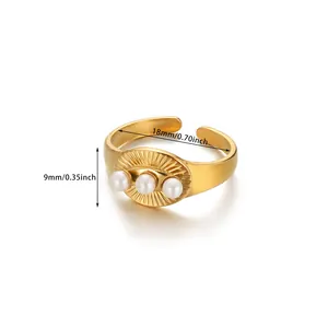 Detail view of gold stainless steel ring with three pearls and sunburst texture