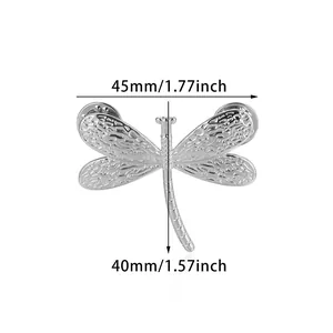 Detailed silver dragonfly brooch back view showing texture and dual pin fastenings