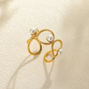 Detail of golden multi-layer ring with pearls and intricate twisted rope texture