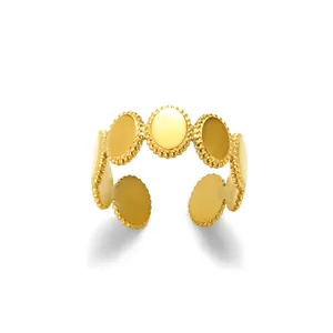 Detail of gold-plated milgrain adjustable ring featuring oval textured patterns