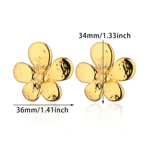 Detail view of gold flower earrings with hammered texture and 34mm by 36mm dimensions