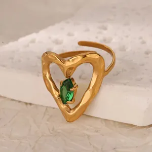 Detail eines 18K Goldrings mit grünem Marquise-Zirkon und gehämmerter Herztextur