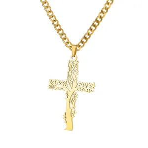 Close-up of gold cross pendant with tree texture and polished curb chain detail