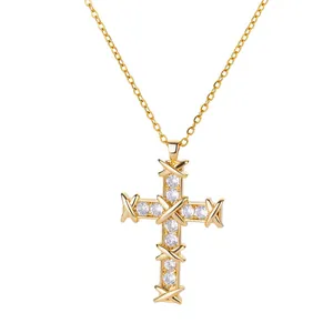 Detail of gold cross pendant with cubic zirconia and signature X-shaped cross symbols