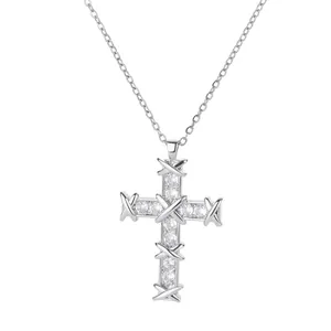 Detailed macro of silver cross pendant with micro-pave zircon stones on thin chain