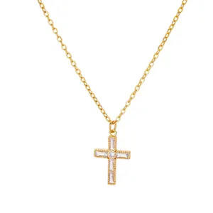 Detailed close-up of a gold cross necklace pendant set with sparkling zircon crystals