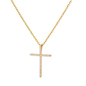 Detail view of a gold cross pendant necklace inlaid with shimmering white zircon stones