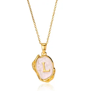 Detail of 18K gold plated necklace featuring 3D letter L pendant with pink enamel texture