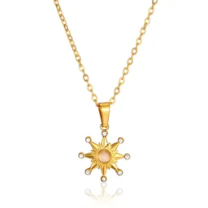 Detailed close-up of golden sun pendant necklace with opal center and zircon accents