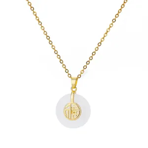 Detail of gold necklace with white ring pendant and engraved Fu character for luck