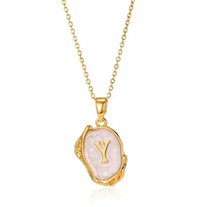 Macro view of 18K gold plated necklace featuring an oval pendant with letter Y inlay