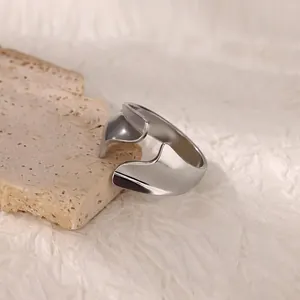Detail view of silver abstract irregular geometric open ring on stone texture